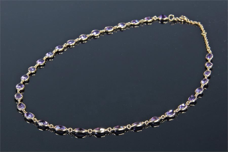 18 carat gold amerthyst set necklace, with a row of 32 set in oval mounts, length 48cm