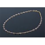 18 carat gold amerthyst set necklace, with a row of 32 set in oval mounts, length 48cm