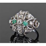 White metal diamond and emerald set ring, the banded domed ring with eleven brilliant cut diamond