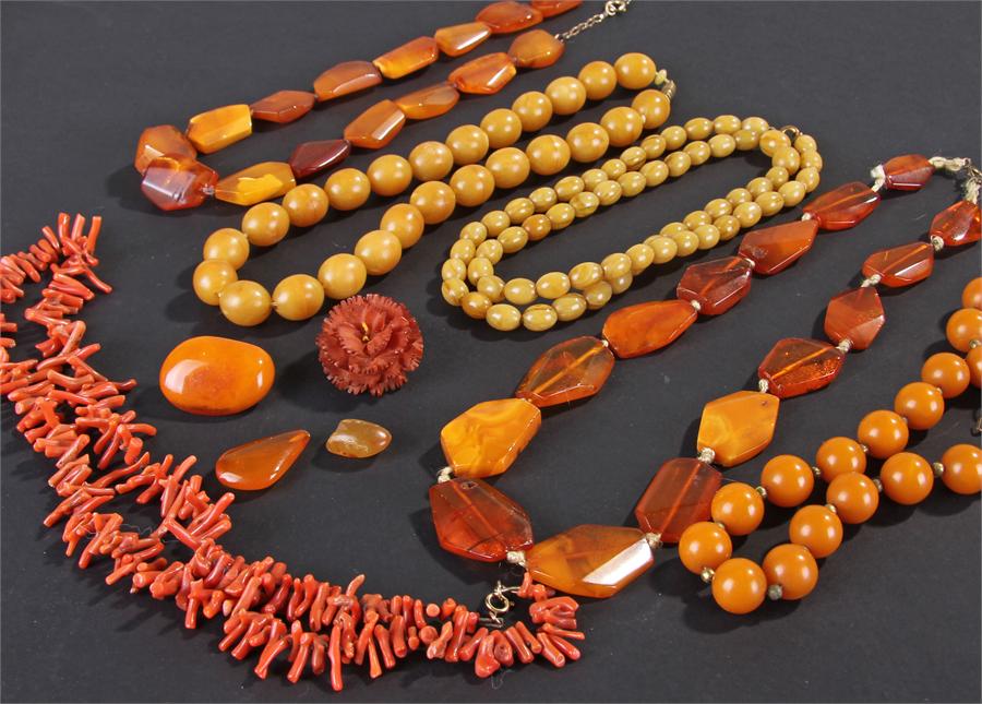 Collection of Bakelite amber, with necklaces and brooches, together with a coral necklace, (qty)