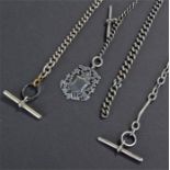 Three silver pocket watch chains, one with a T bar and medal, another with plated T bar and clip,