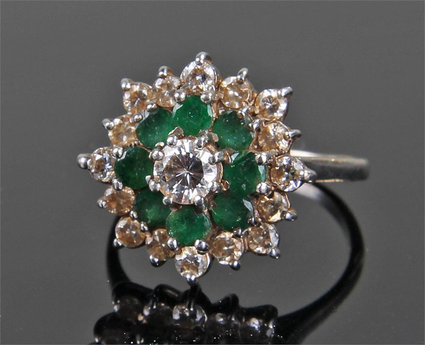 18 carat white gold, diamond and emerald cluster ring, the central approximately 0.46 carat