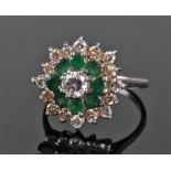 18 carat white gold, diamond and emerald cluster ring, the central approximately 0.46 carat