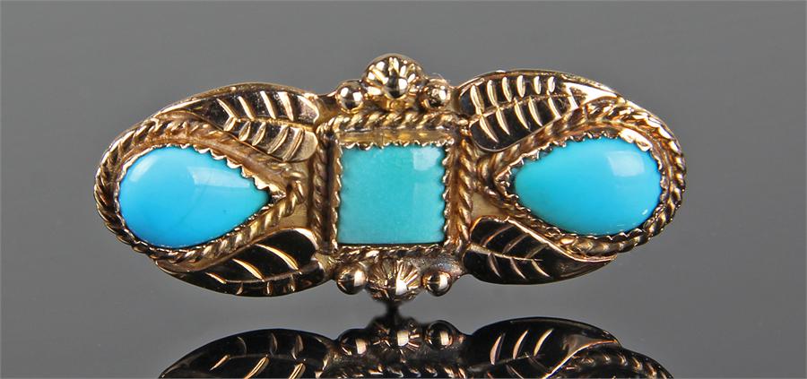 14 carat gold turquoise set brooch, by D Benally, the central square turquoise flanked by a