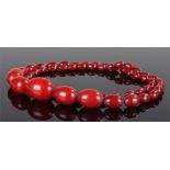 Large Art Deco Bakelite cherry amber necklace, with a graduated set of beads, the largest bead