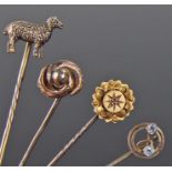 Four stick pins, to include a 9 carat gold with two topaz set stones, a sheep example, a 15 carat