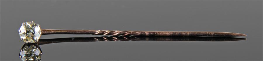 Single diamond set stick pin, the single diamond at approximately 0.80 carat, raised on a gold pin