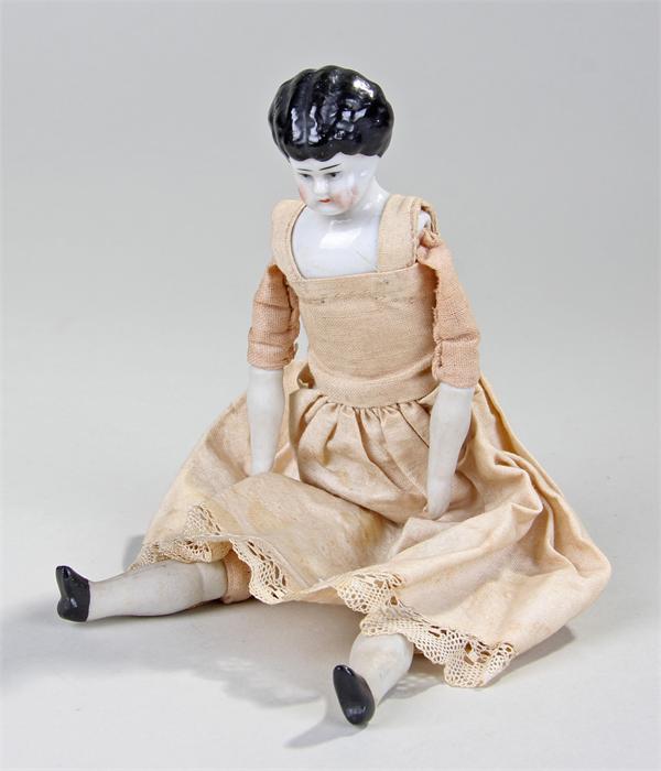 Victorian porcelain doll, with a porcelain head, original clothing and bisque porcelain hands and