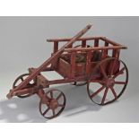 Early 20th Century treen miniature model child's toy cart, painted in brick red, with a galleried