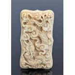 19th Century Chinese Canton ivory card case, with a deeply carved dragon to the front, the rear with