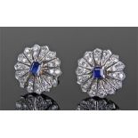 Pair of white metal diamond and sapphire earrings, the central princess cut sapphires surrounded