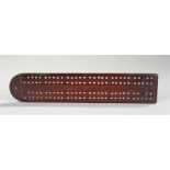 19th Century mahogany cribbage board, with geometric circle design, brass feet to the base, 24cm