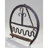 18th Century hanan or 'bread warmer', with hooked and wavy central decoration, horse shoe shape