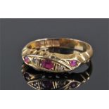 18 carat gold ruby and diamond set ring, with three rubies, the central ruby flanked with