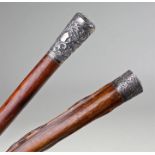 Two 19th Century silver capped walking canes, the