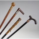 Group of four Victorian walking sticks, two with r