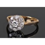 18 carat gold and diamond cluster ring, with a cen