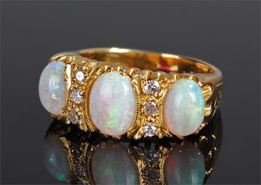 18 carat gold opal and diamond ring, with three op