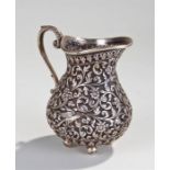 19th Century Indian white metal jug, in high relie