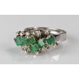 18 carat white gold emerald and diamond ring, the