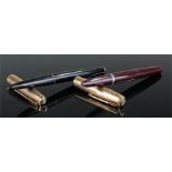 Two Parker fountain pens, one black and one brown with a gold coloured lids