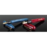 Two pens, a red Morrison fountain pen with 14 carat gold nib and a blue swan safety pen with 14