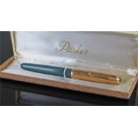 Parker fountain pen with gray body and gold filled lid, housed within a Parker box