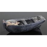 Carved wooden model boat. 21cms bow to stern.