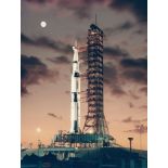 View of the giant Saturn V rocket on the pad at dawn with the Moon in background, Apollo 4, 9