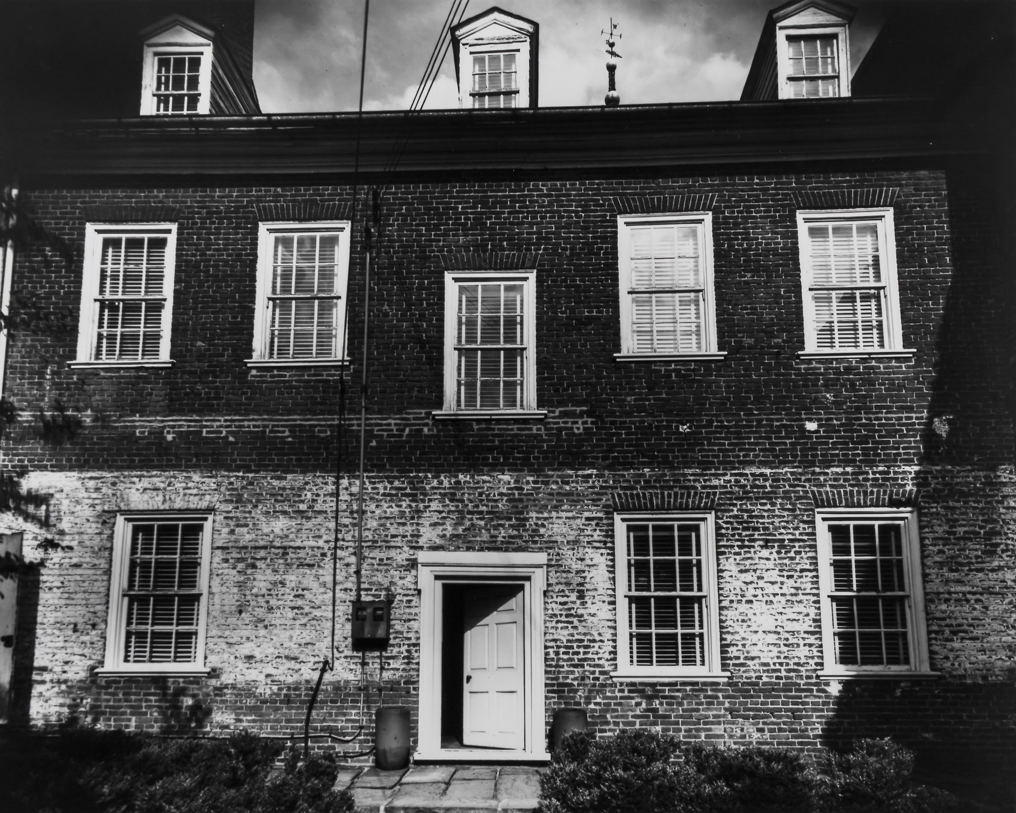 Berenice Abbott (1898-1991) - Housefront in Soho, 1937 Gelatin silver print flush mounted to card,