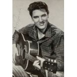 PRESLEY, ELVIS - Glossy black and white photograph of the singer holding a guitar... Glossy black