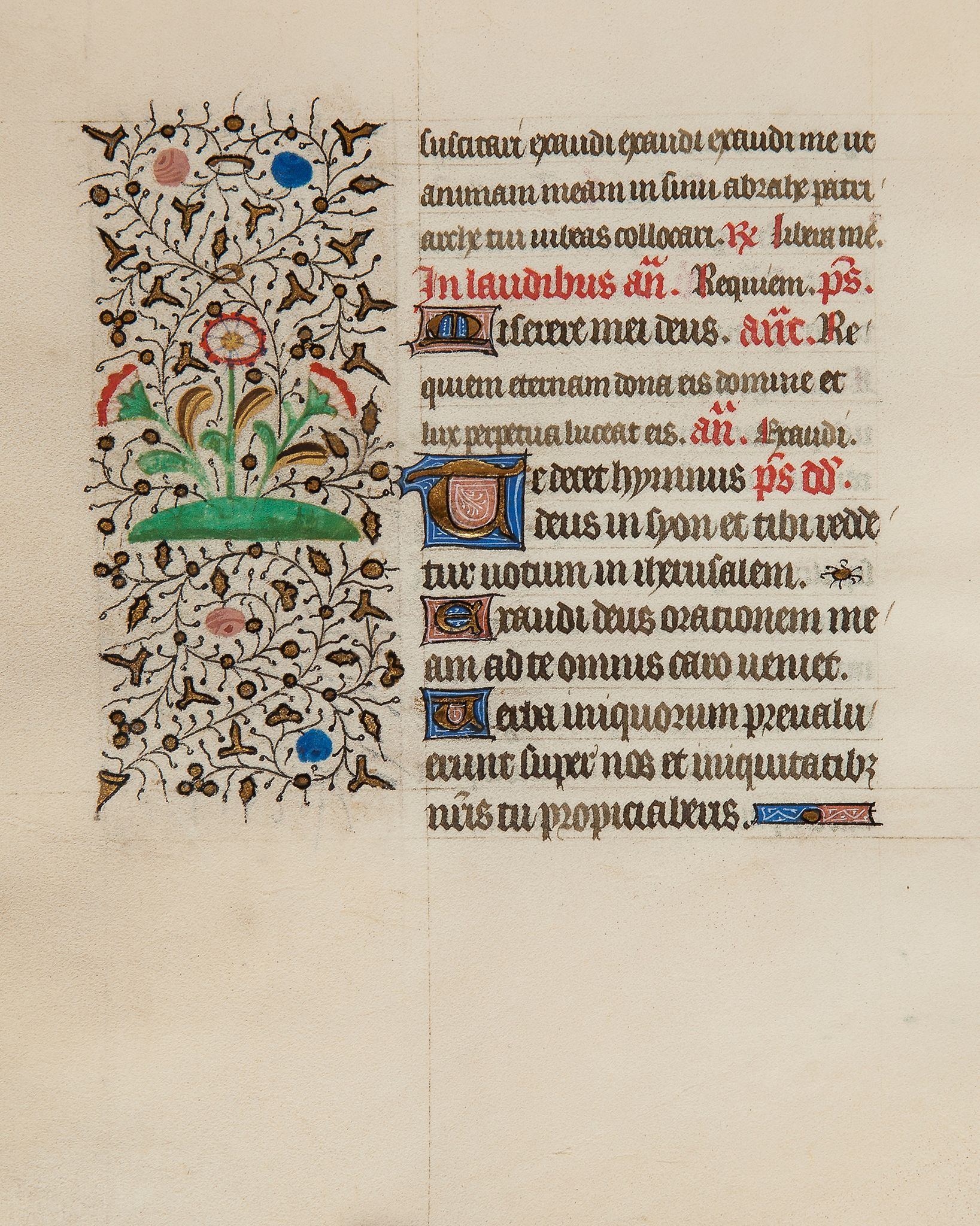 Young saint holding a book, - in an initial on a leaf from an illuminated Psalter  in an initial