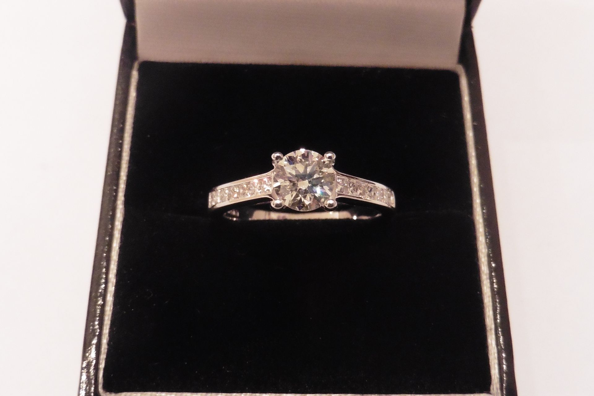 A beautiful diamond set solitaire ring set with a centred russian cut diamond, of VS clarity, I colo