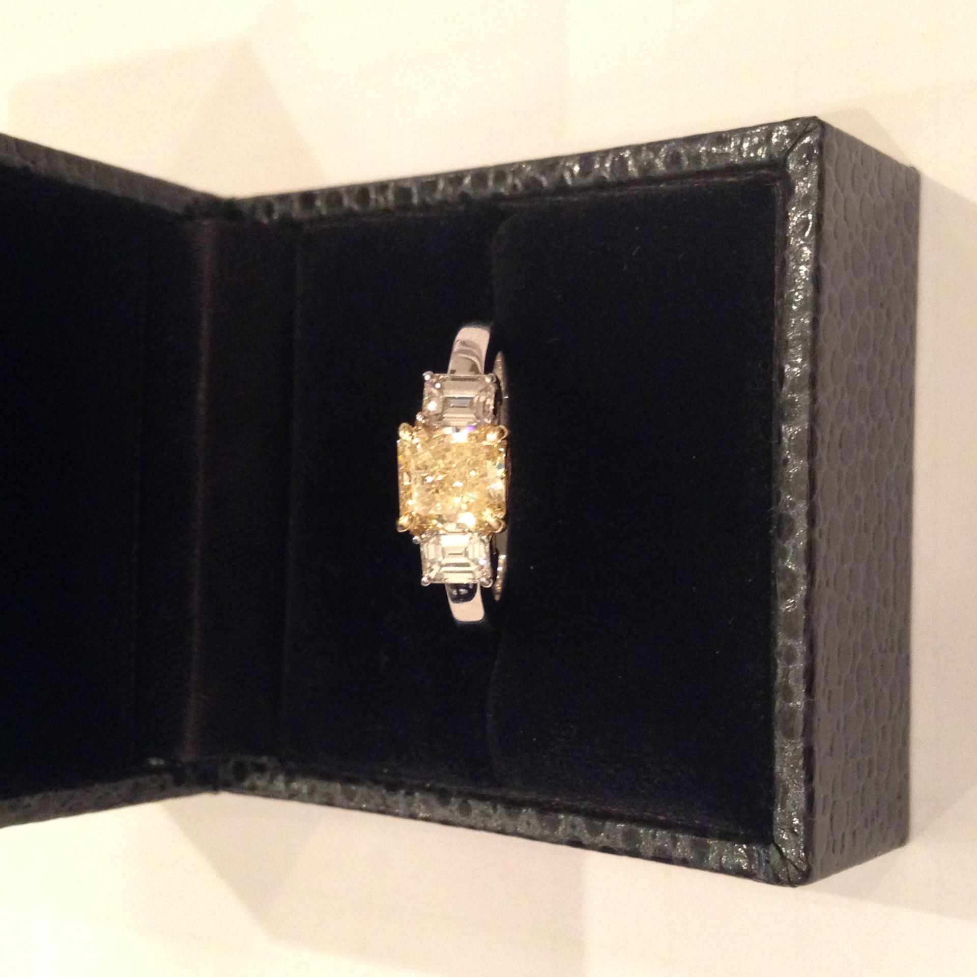 Beautifully set platinum and 18ct yellow gold diamond three stone ring.  Set in the centre is a fanc