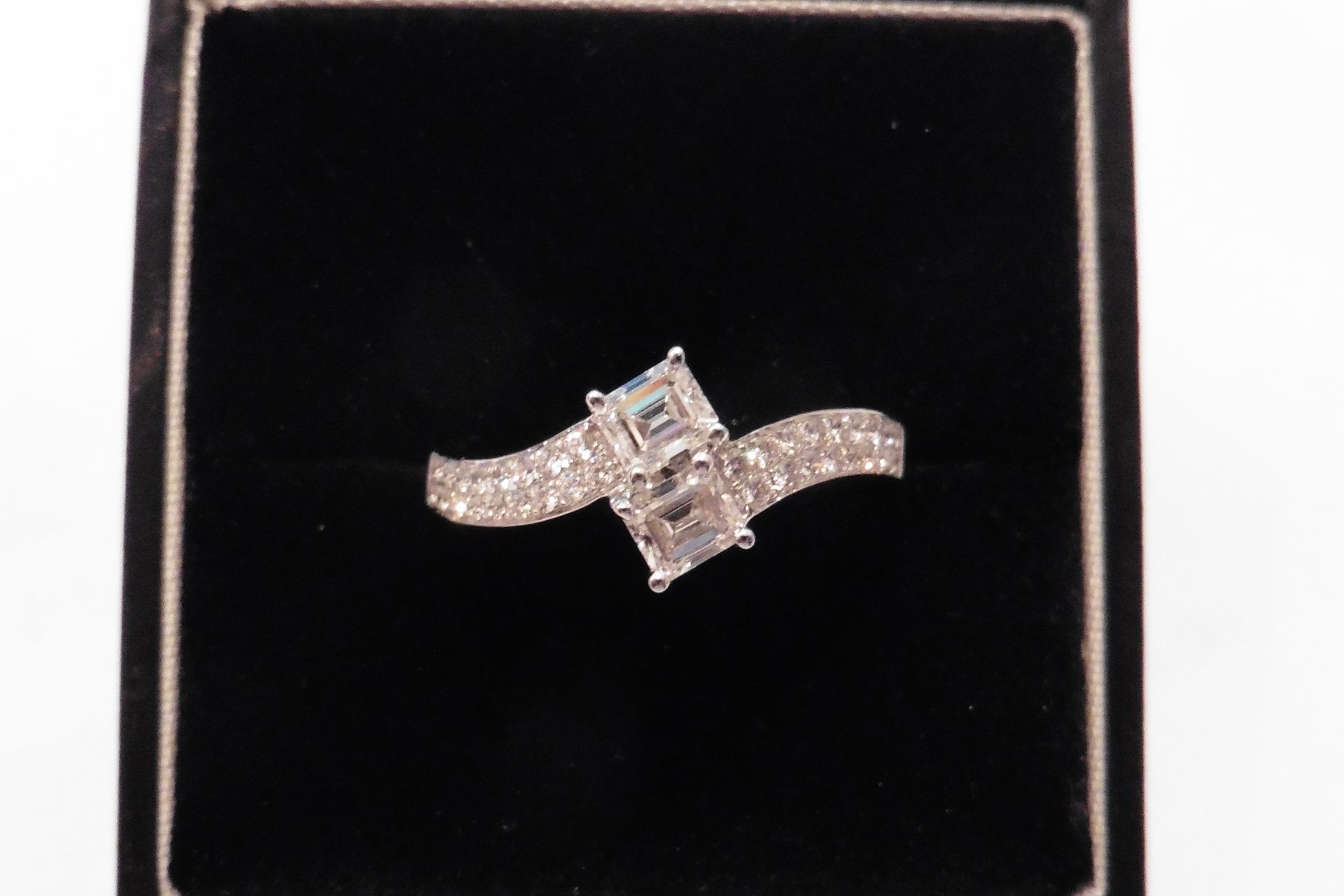 18ct gold diamond twist ring with two emerald cut diamonds in the centre, VS clarity, H colour, weig
