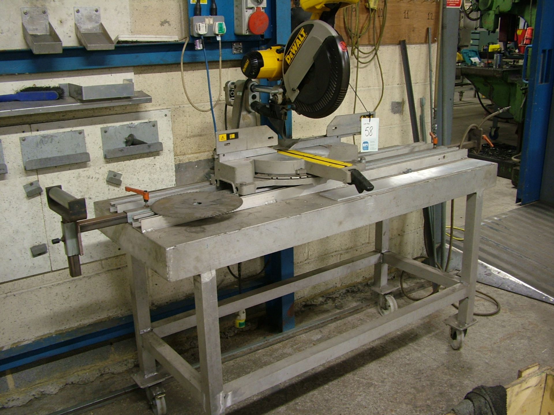 Dewalt DW708-LX type 3 115v pullover saw, mounted on aluminium mobile bench