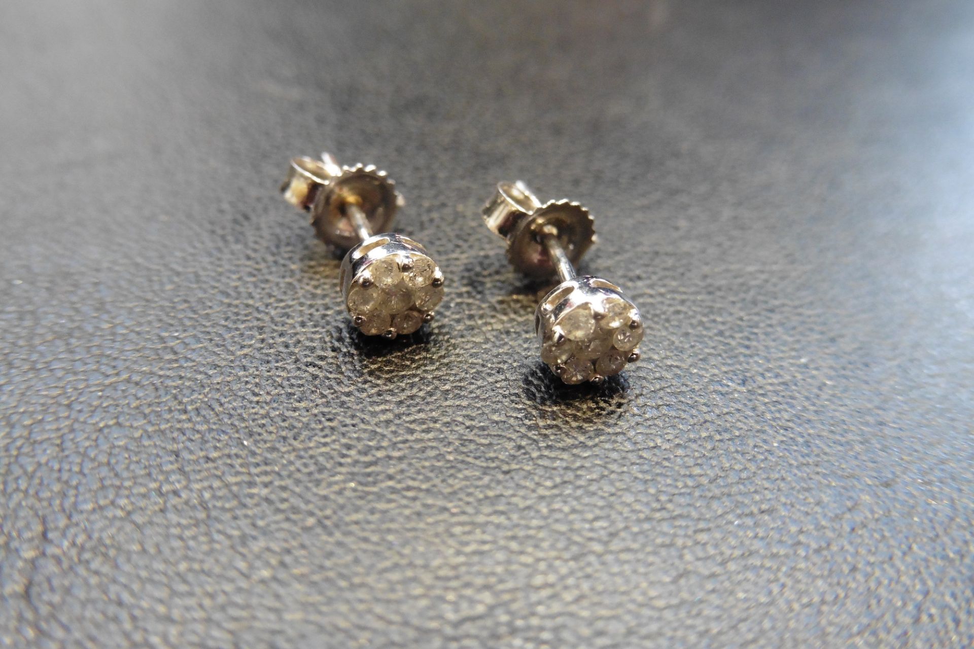 9ct white gold tiny diamond cluster earrings each set with 7 brilliant cut diamonds of P1 clarity we