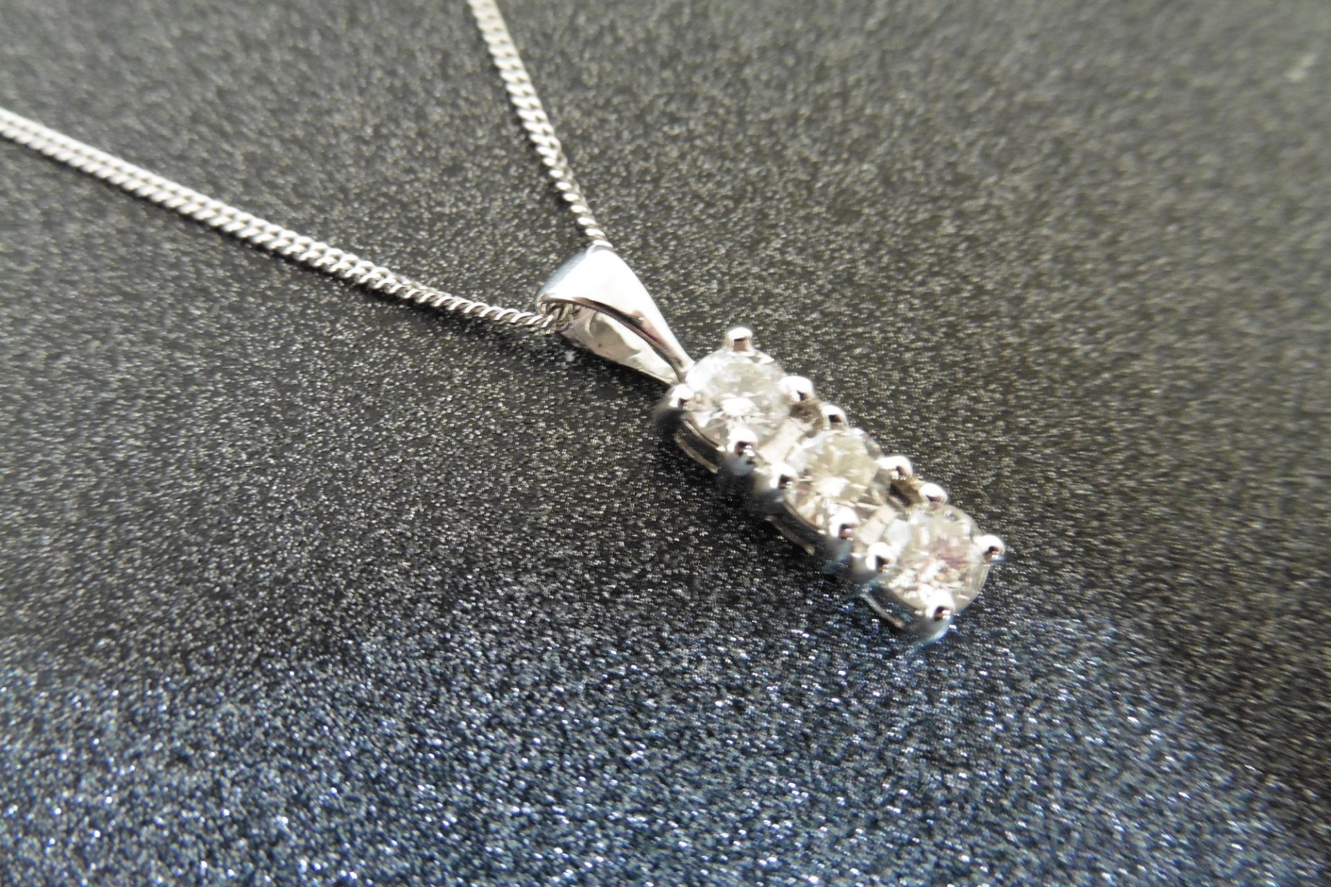 18ct white gold trilogy pendant set with 3 small brilliant cut diamonds of H/I colour weighing a tot