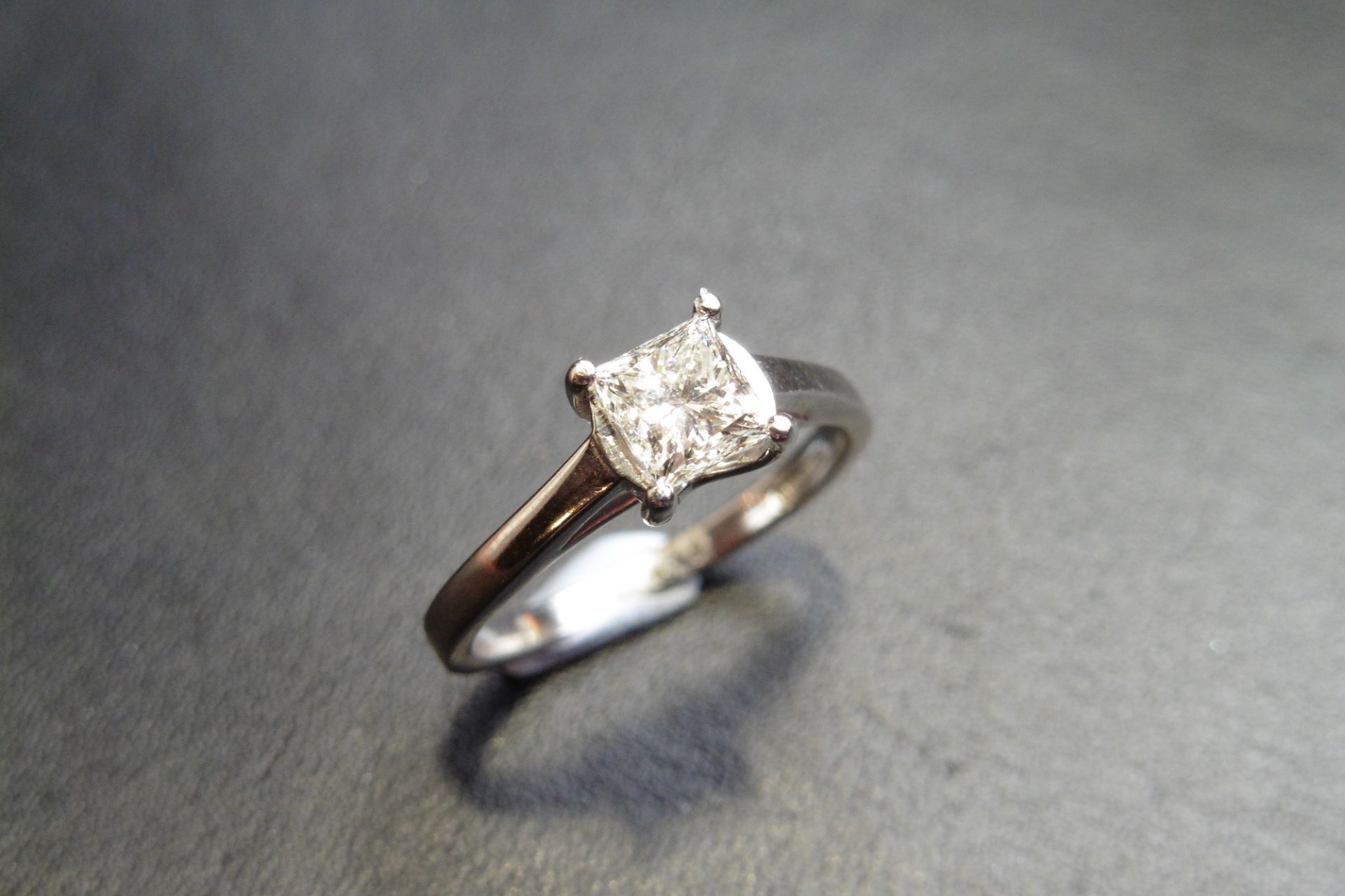 Platinum diamond solitaire ring set with a 0.75ct princess cut diamond, of I colour and VS2 clarity.