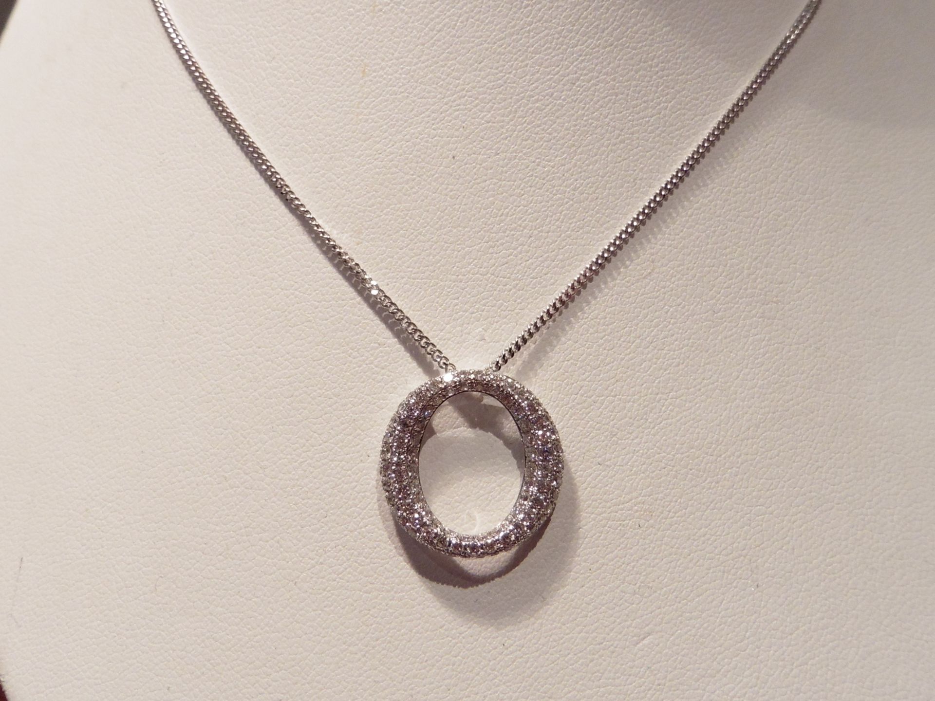 18ct white gold diamond set pendant in an 'o' design.  Set with tiny brilliant cut diamonds weighing - Image 2 of 2