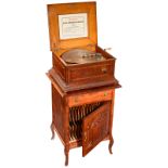 Rare Coin-Operated "Regina No. 15"
15 ½-inch disc musical box. Table model on disc storage cabinet