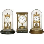 3 German Torsion Pendulum Clocks, 1920 onwards
Anniversary clocks. 1) With calendar, wooden base,