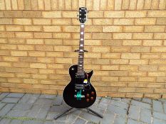 An Eros Les Paul Black Beauty style electric guitar with new pack of strings,