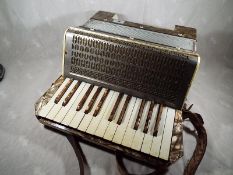 A vintage Mastertone German piano accordion in hard case - included in the lot are four music books