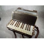 A vintage Mastertone German piano accordion in hard case - included in the lot are four music books
