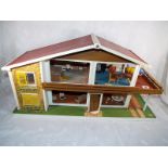 A vintage Toy Works Ltd oak leaf dolls house, over two floors with balcony, internal light fittings,