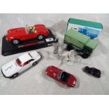 A small collection of diecast models comprising a Burago Ford AC Cobra 427 (1965),