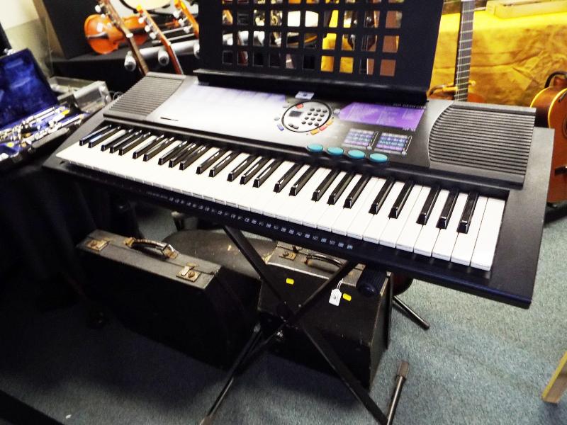 A Yamaha PSR-185 electronic keyboard with soft case, stand and power lead