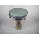 An unusual white metal djembe drum with embossed decoration,