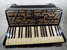A Hohner Verdi IV piano accordian,